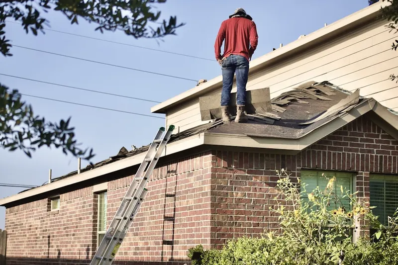Professional roofer working on a residential roof in Mattoon
